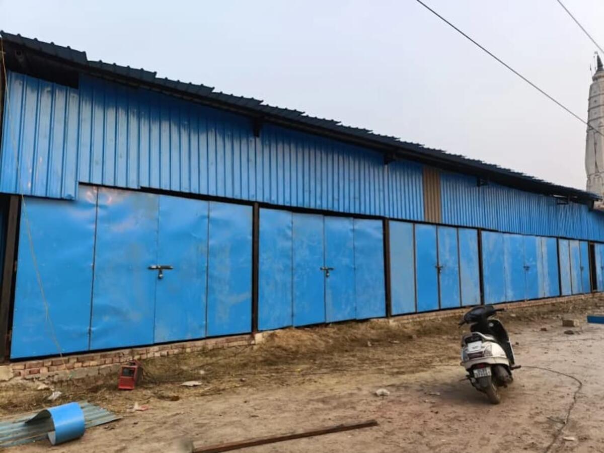 Blue tin shed with rolling shutters — R.R Teen Set Solution