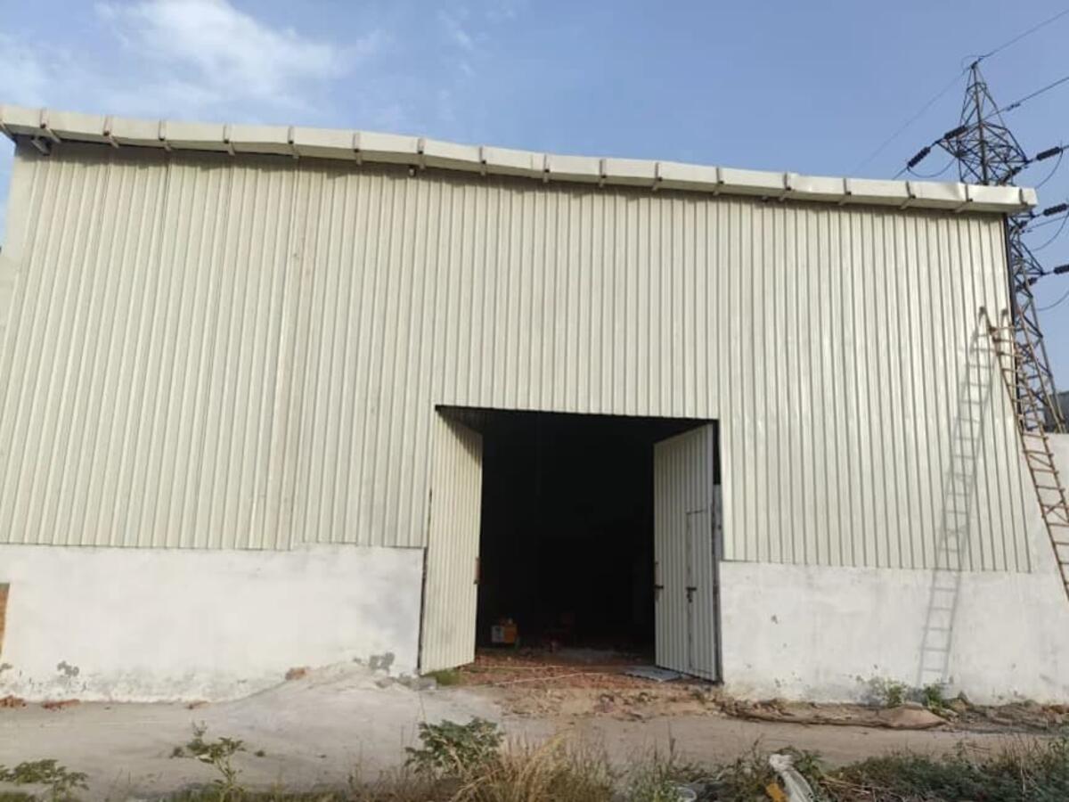 Completed prefab warehouse shed with large entry gate — R.R Teen Set Solution